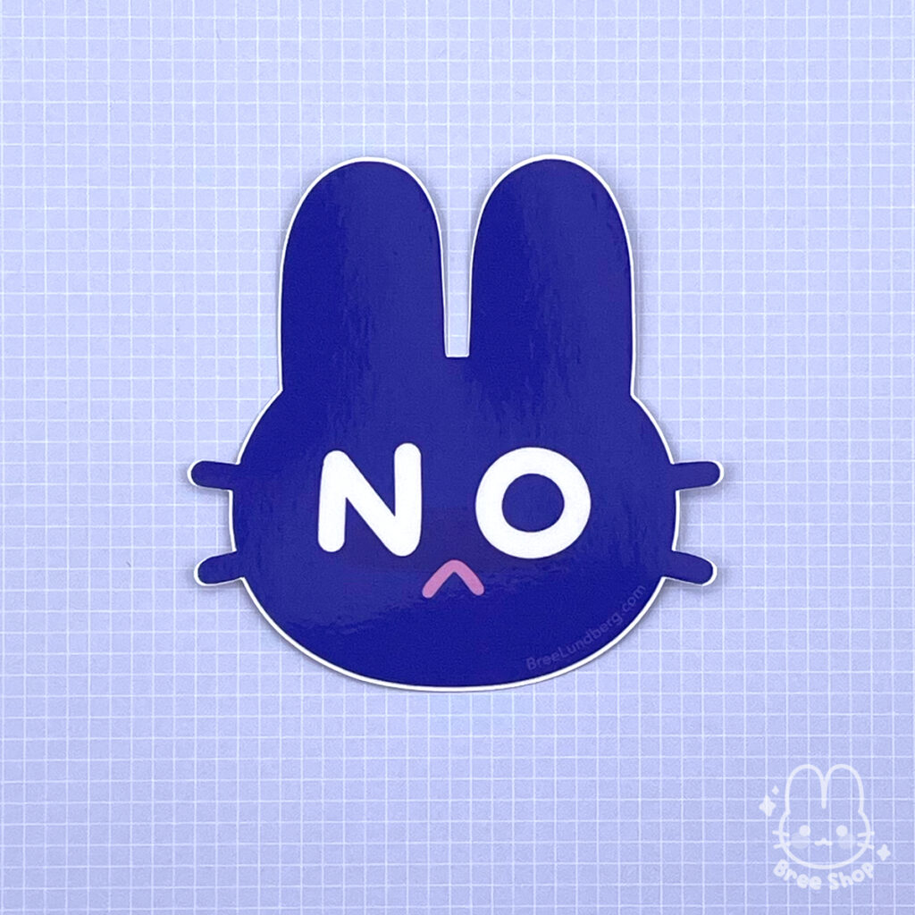 Photo of a dark blue sticker cut in the shape of bunny face, big white letters "N" and "O" represent where the eyes should be and there is a pink frowning mouth.