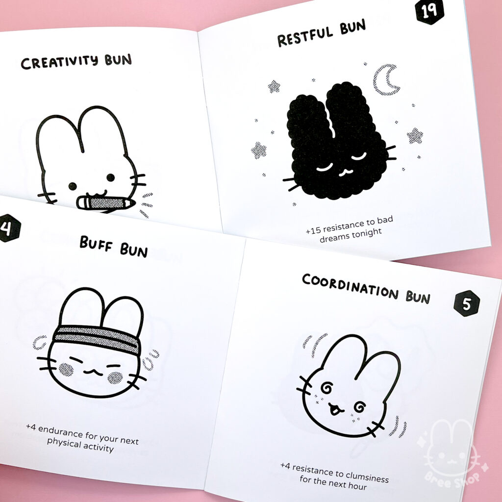 Photo of two Lucky Bun zines laying open showing several numbered pages of different cute illustrated black and white bunny faces and their bonuses. One is a "Coordination Bun" that says +4 resistance to clumsiness for the next hour.
